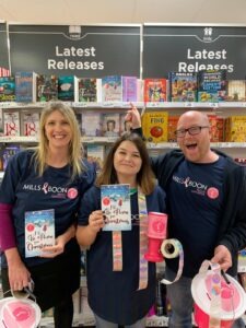 Our team holding a copy of I'll Be Home for Christmas in Asda